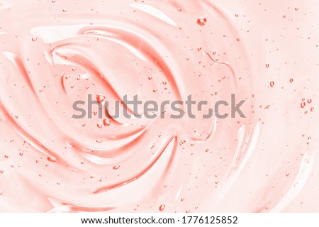 Beauty serum gel texture. Pink clear skincare cream with bubbles background. Transparent colored cosmetic product close up  Royalty-Free Stock Photo #1776125852