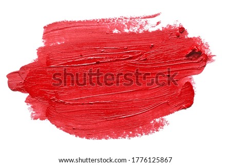 Red lipstick brush strokes isolated on white background. Bright color makeup smear smudge swatch. Creamy lipstick texture