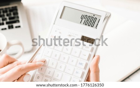 Close up businessman hand using calculator and writing make note with calculate about finance accounting.finance accounting concept. High quality photo
