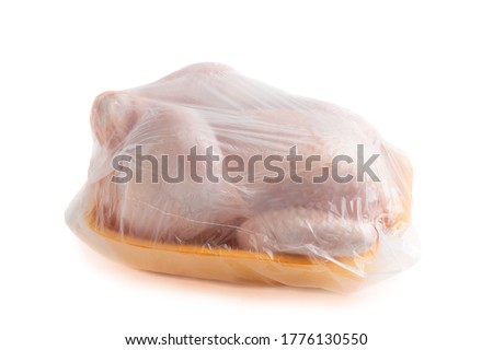 Whole raw chicken carcass on a shopping tray in a bag isolated on a white background with clipping paths with shadow and without shadow
