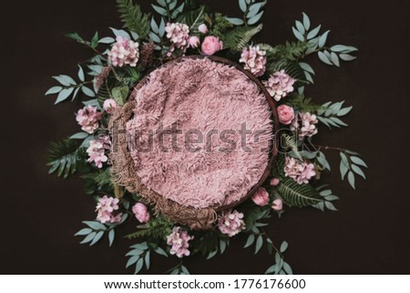 Newborn digital background - brown wooden bowl with green leaves wreath, flowers and pink layer.