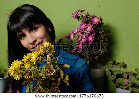 young woman with flowers on home patio