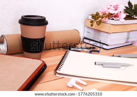 Image of a vintage style office desk with work materials such as notebooks and special equipment for technical drawing