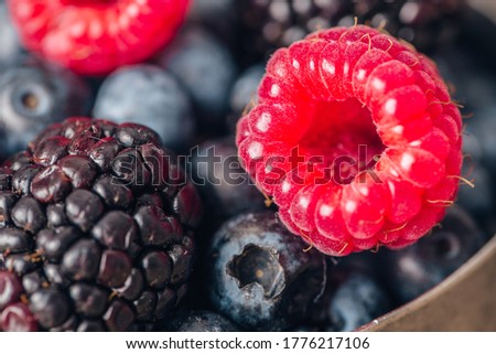 Summer Berries mix with Raspberry, Blueberry and Blackberry on wood background.