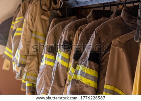 Firefighter's uniforms and gear arranged at fire station