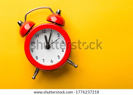 Clock is isolated on the yellow background.