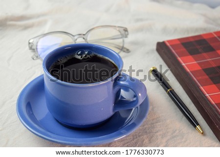 Cup Of Coffee with pen,book and glasses on white background. relax with coffee concept