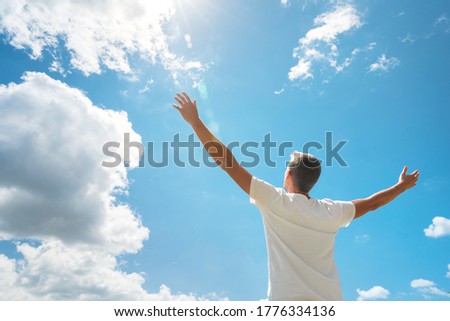 Man strive hands to the deep blue sky and sun. Religion and conceptual scene. Worship to God.  Royalty-Free Stock Photo #1776334136