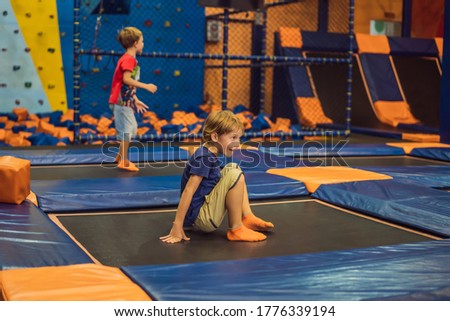 Cute boy jumping on trampoline in entertainment center Royalty-Free Stock Photo #1776339194