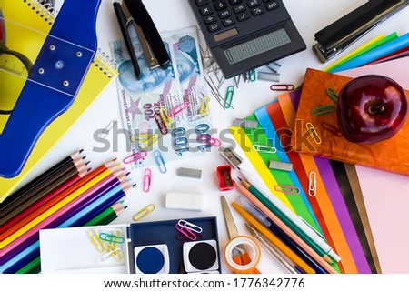 Colorful school supplies on white background with Turkish Money.School shopping concept.