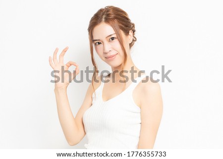 Young woman making an OK gesture