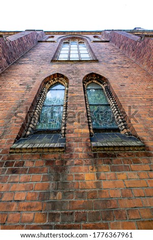 Stained glass windows in a gothic church. Catholic temple in Central Europe. Summer season.