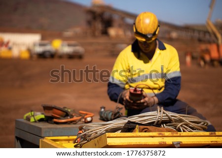 Safety workplace clear picture of power cord defocused trained competent electrician setting holding red electricity tester, conducting safety testing inspecting tagging light prior used background 