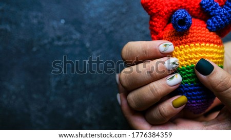 Women's hands with colorful patterns on the nails. Summer colors trend. Top view. The place for text.