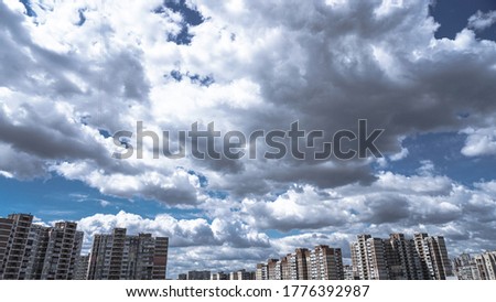 Apartment buildings on a background of beautiful clouds. High-rise buildings are built with panel construction in which people live.photo background