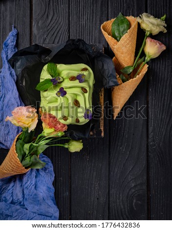 
pistachio ice cream in a cone in a wooden box