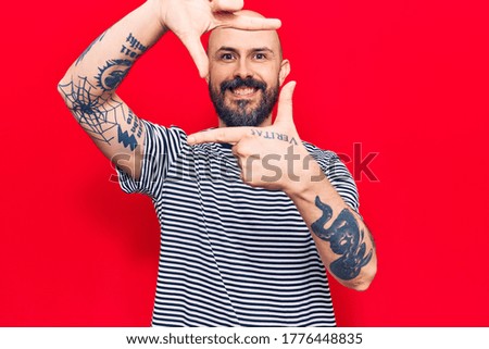 Young handsome man wearing casual clothes smiling making frame with hands and fingers with happy face. creativity and photography concept. 
