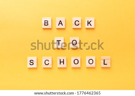 Words Back to school on yellow background. Education, back to school concept, top view, flat lay - Image