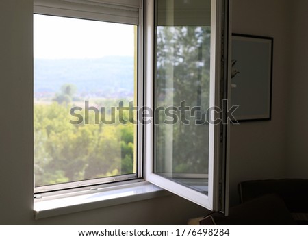 Open window with nature landscape view from inside house, apartment interior