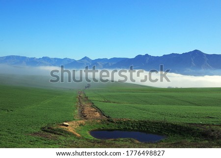 The winter landscapes in the Overberg can be gorgeous on
winter mornings with mist close to the mountains. This picture was taken near Riviersonderend in South Africa