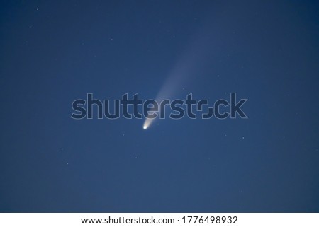 Comet Neowise in night sky close up. Astronomy. Night sky background.                               