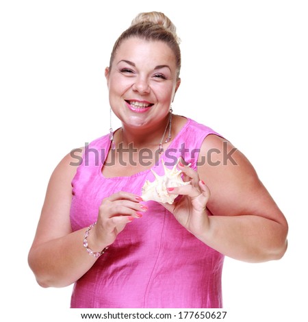 Studio image of European pretty woman with a cute smile, holding a seashell isolated on white