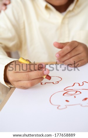 Hand of a child to draw a picture