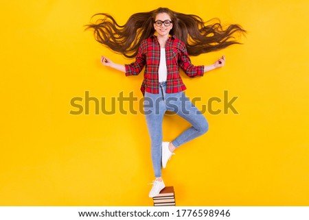 Top view above high angle flat lay flatlay lie concept of nice calm cheery girl nerd meditating standing on pile book isolated bright vivid shine vibrant yellow color background