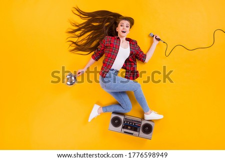Top view above high angle flat lay flatlay lie concept of glad positive cheerful funky girl singing song flying enjoying weekend isolated on bright vivid shine vibrant yellow color background