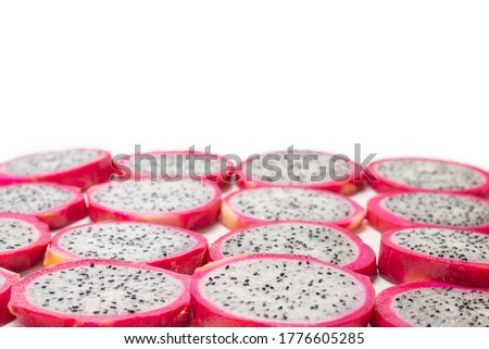 Sweet tasty dragon fruit or pitaya slices as a background.