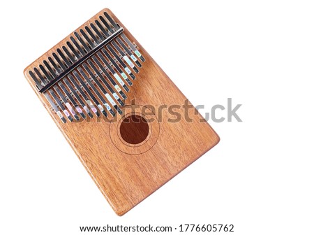 Top view wooden african instrument Kalimba musical isolated on white background.  play on hands and plucking the tines with the thumbs.