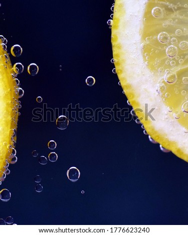 Lemon creating bubbles in clear water