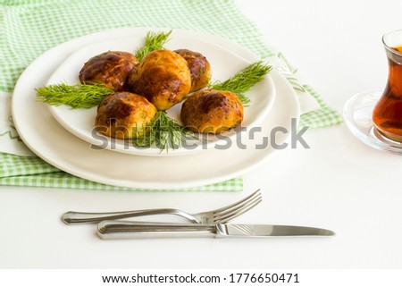 Homemade salty pastry on white background with traditional Turkish Tea.