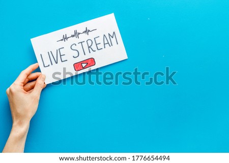 Live streaming web network concept. Female hands holding paper tablet. Top view