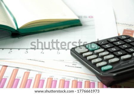  financing. calculator and pen heals on a financial chart. High quality photo