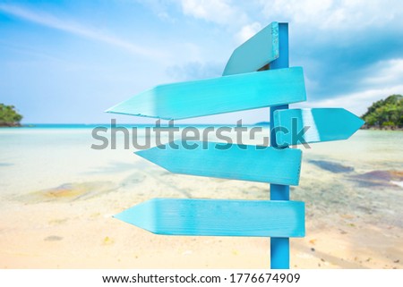wooden sign on sand beach for outdoor advertising summer vacation concept.
