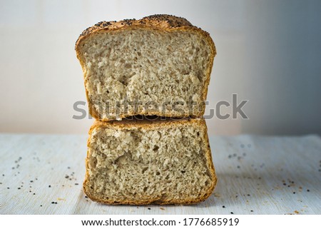 wholemeal bread with chia seeds broken in half isolated on white and copy space top