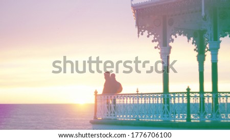 a couple at sunset pastel beach ,Blurred picture use for background  