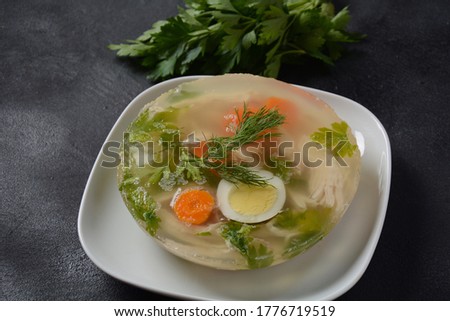 Home made aspic, jellied chicken meat with herbs and carrots. Traditional Russian dish holodets. Served with bread and mustard or/and horseradish