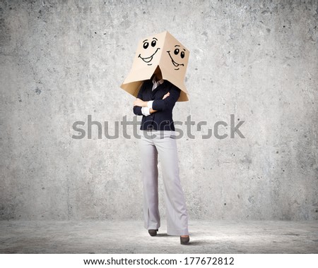 Confident businesswoman wearing carton box on head