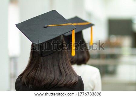 Picture of a black hat with yellow tassels from a university graduate.