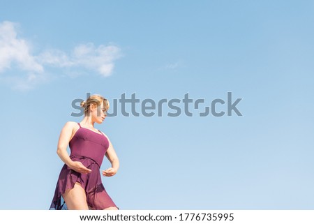 young caucasian ballet dancer posing with the sky in the background, dance and freedom concept, copy space for text