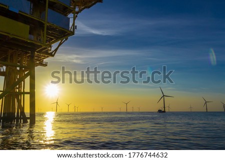 North Sea offshore wind farm substation and the sunset Royalty-Free Stock Photo #1776744632