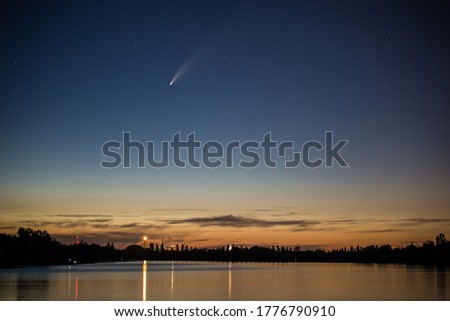 Neowise comet over a lake in Hungary at dawn
