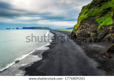 Aerial view of the Reynisfjara black sand beach with Dyrholaey peninsula in the background. This popular icelandic beach is located near Vik i Myrdal in south Iceland.