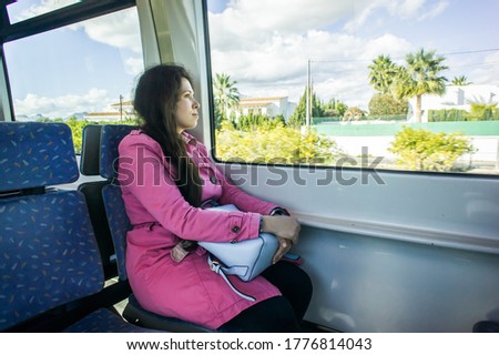 Young woman traveling by train. Travel, transport and vacation concept.