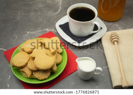 Cookies in a plate and coffee with milk
