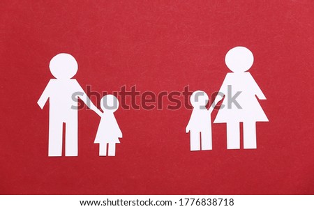 Split paper family on a red background
