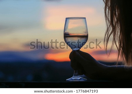Glass of  wine on sunset background. 