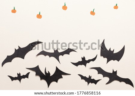 Black bats paper cut background. Halloween background. Cute cartoon spooky character. Flat lay.